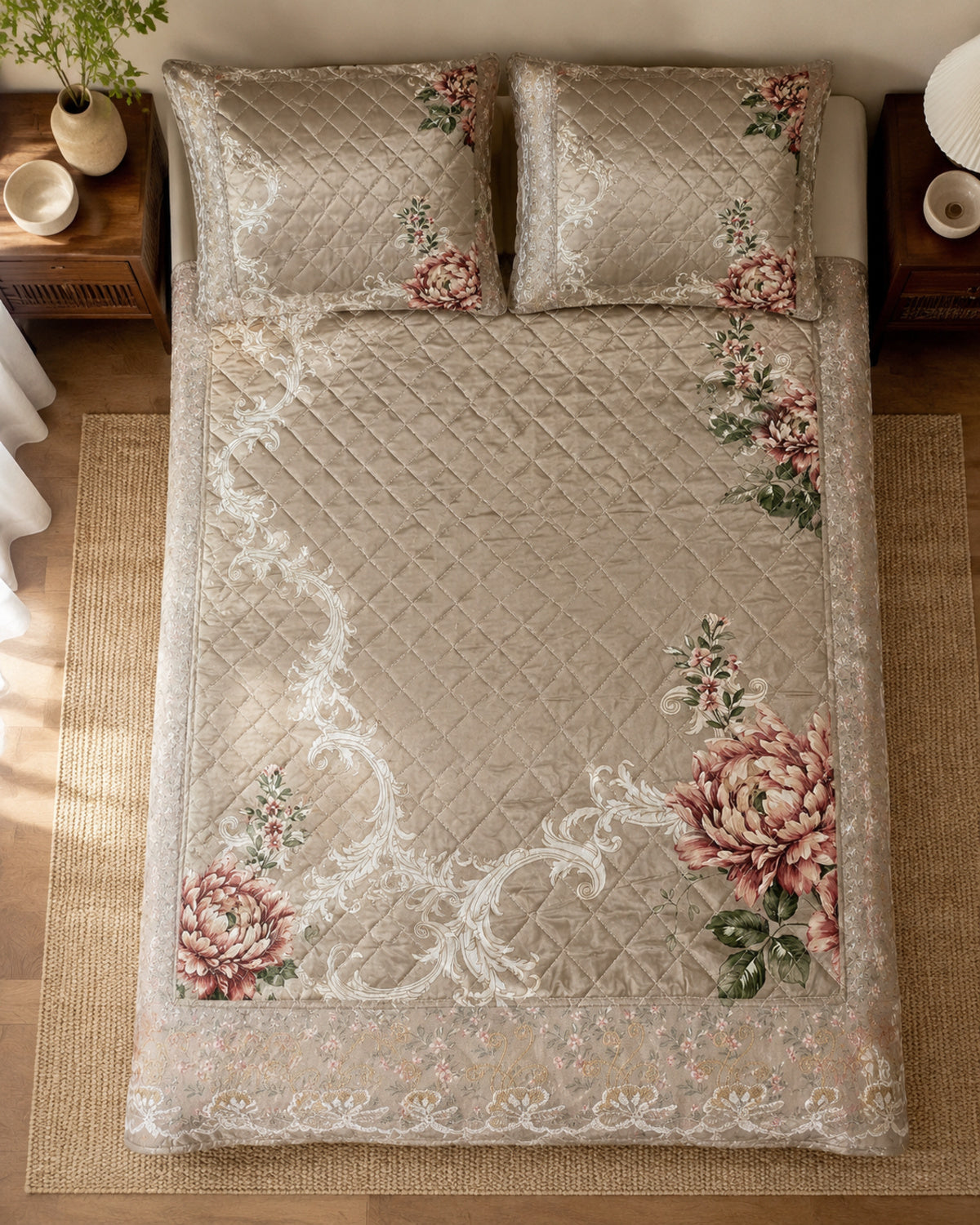 Overhead view of taupe rose botanical printed silk bedspread and two pillow covers