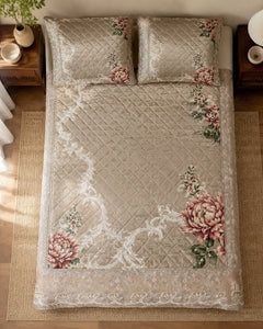 Overhead view of taupe rose botanical printed silk bedspread and two pillow covers