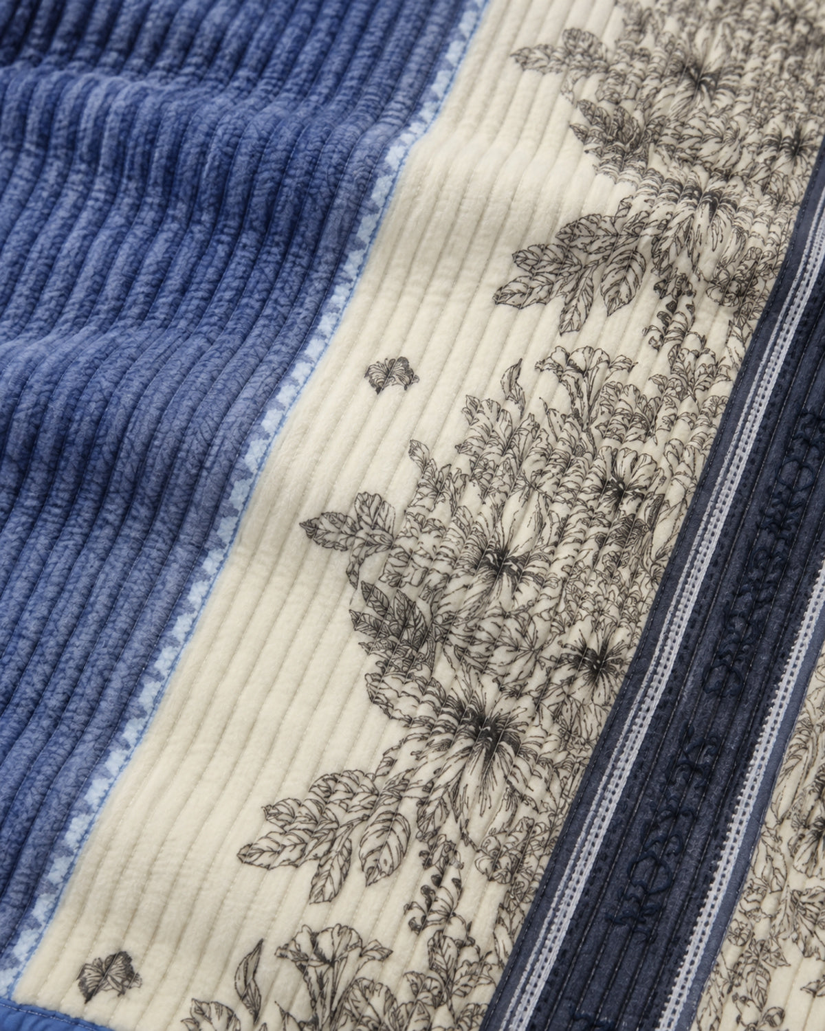 Close-up of ribbed blue and ivory botanical Smartchoice comforter fabric