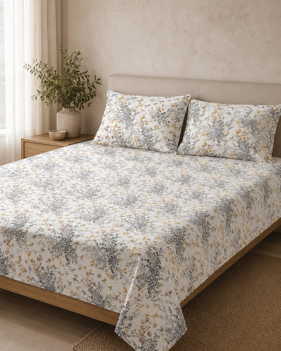 Ivory Meadow Cotton Bedsheet Set on a king bed, front hero view